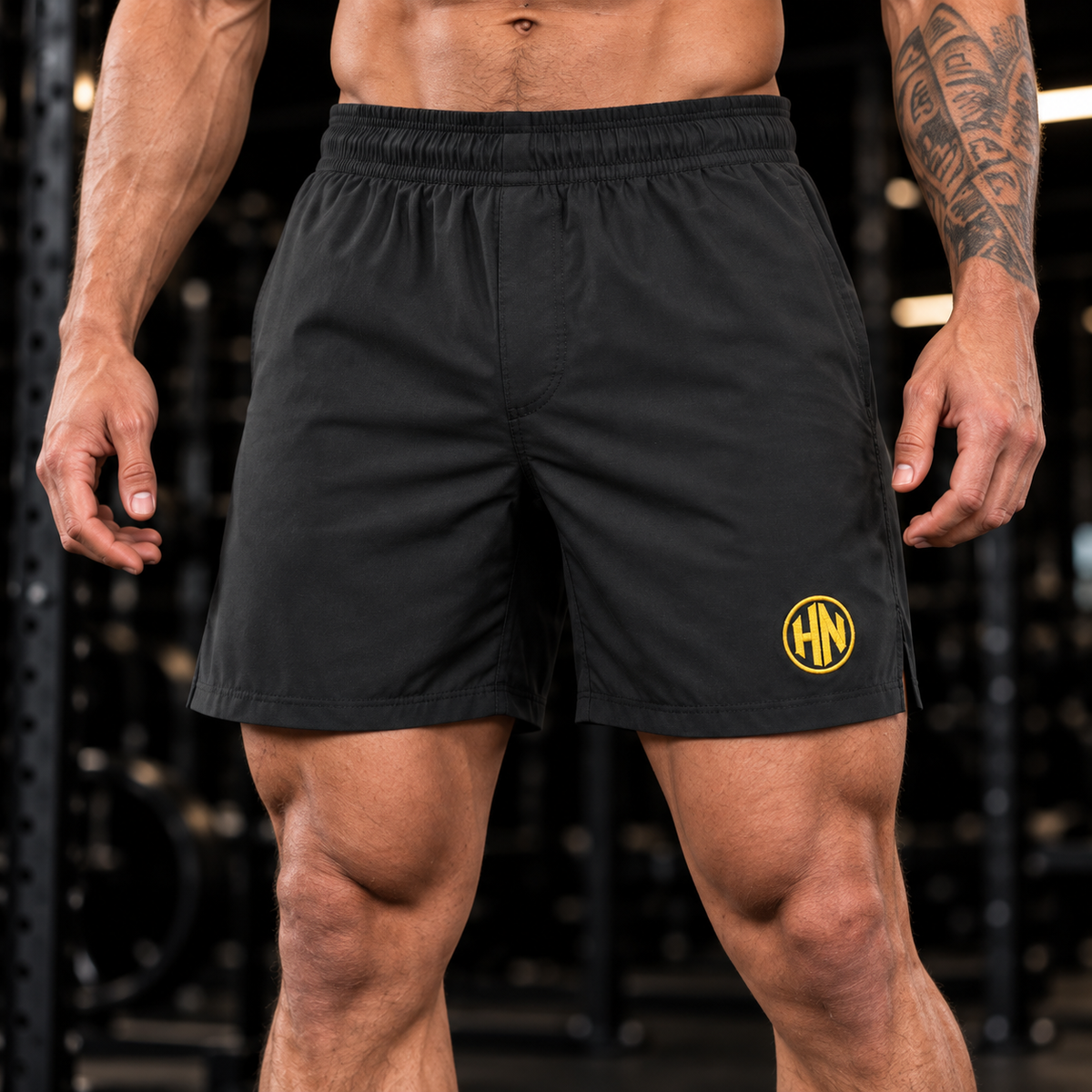 Close-up of the elastic waistband and gold logo on black Hack Pro Essential Shorts