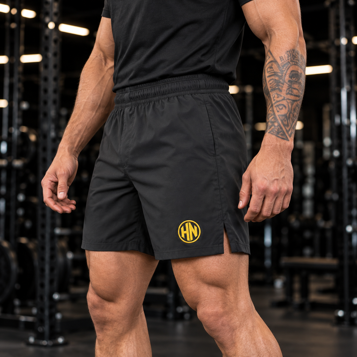 Side detail of black Hack Pro Essential Shorts worn with a black T-shirt