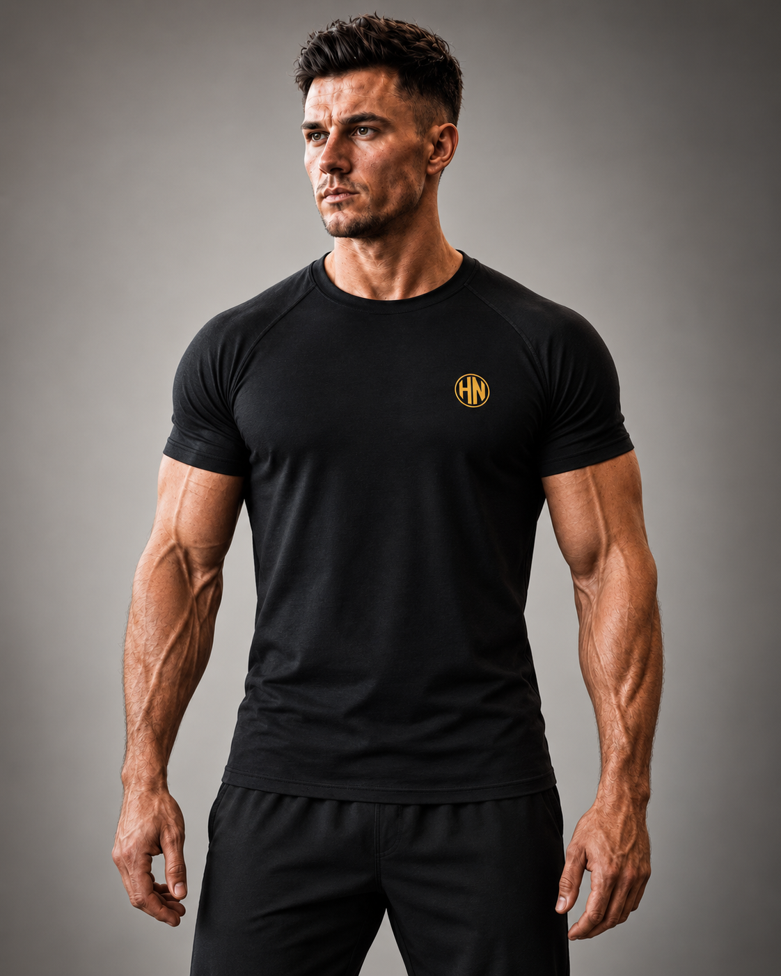 Front view of a black Hack Pro Essential T-shirt with gold chest logo